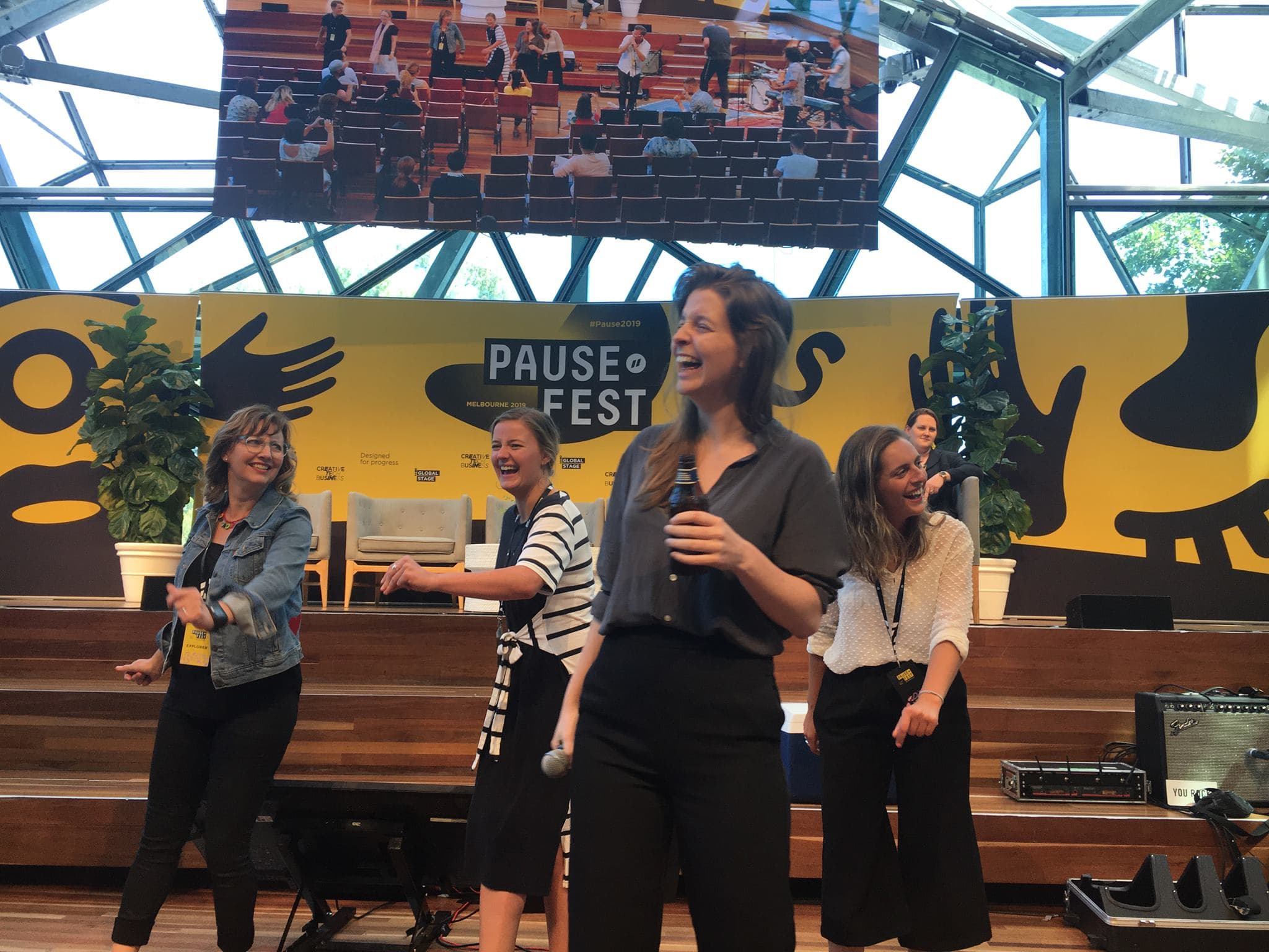Lucy speaking at Pause Fest about 10k Customers